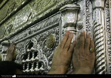 Islamic Architecture - Pilgrims touching the contours of the tomb of Fatima Masuma in the holy city of Qom.